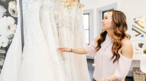 Bridal gown shopping at SilverFlame with a woman selecting wedding dresses in a stylish boutique set.